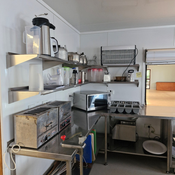 The kitchen area showing toasters, microwave and some equipment