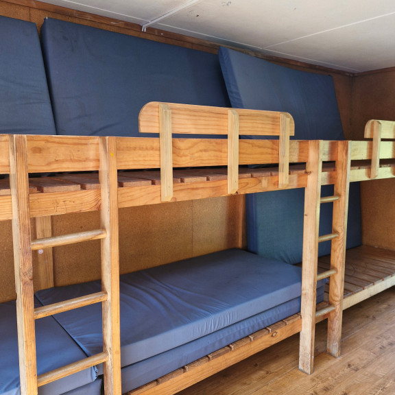 The inside of a cabin showing bunks and mattresses